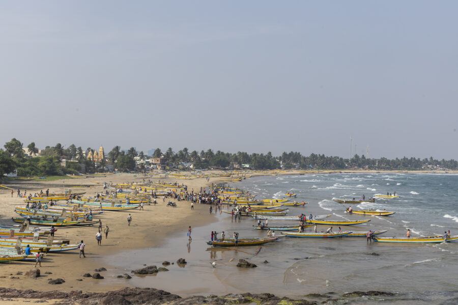 16 November 2022, Pudimadaka, Andhra Pradesh, India- Fishermen return to the landing point on the beach after a hunt. 